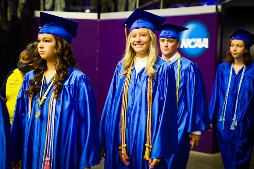 A group of graduates wearing blue robes